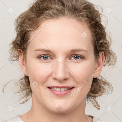 Joyful white young-adult female with medium  brown hair and blue eyes