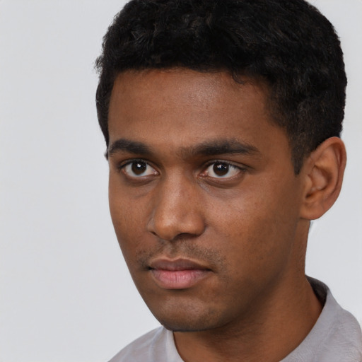 Neutral black young-adult male with short  black hair and brown eyes