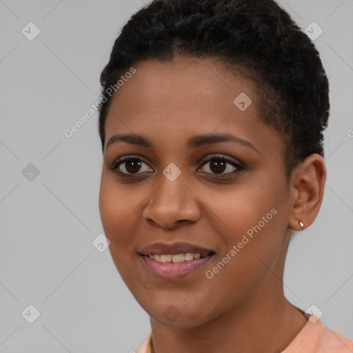 Joyful black young-adult female with short  brown hair and brown eyes