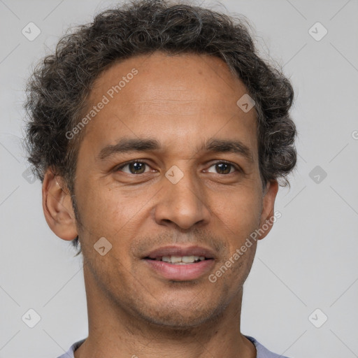 Joyful latino adult male with short  brown hair and brown eyes