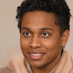 Joyful black young-adult male with short  brown hair and brown eyes