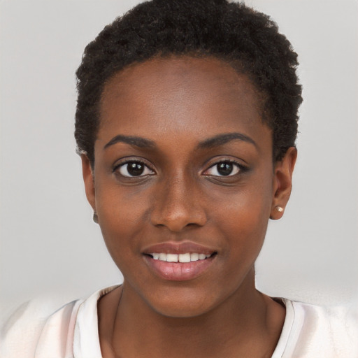 Joyful black young-adult female with short  black hair and brown eyes