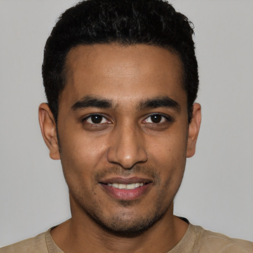 Joyful latino young-adult male with short  black hair and brown eyes