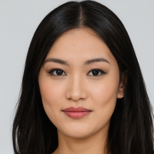 Joyful asian young-adult female with long  black hair and brown eyes