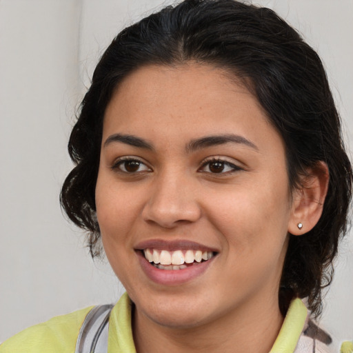 Joyful latino young-adult female with medium  brown hair and brown eyes