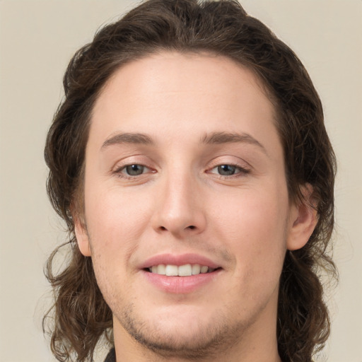 Joyful white young-adult female with medium  brown hair and green eyes