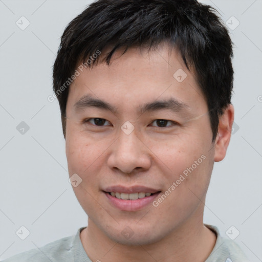 Joyful asian young-adult male with short  brown hair and brown eyes