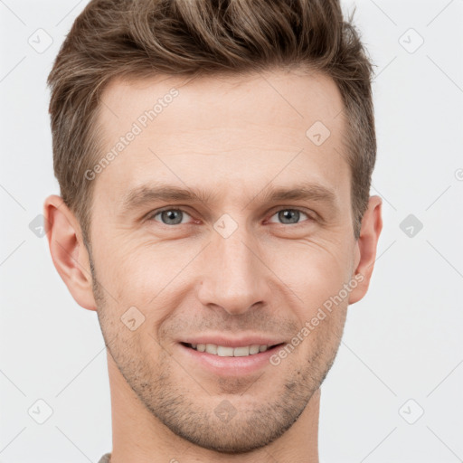 Joyful white young-adult male with short  brown hair and grey eyes