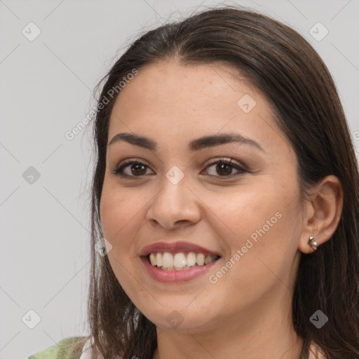 Joyful white young-adult female with long  brown hair and brown eyes