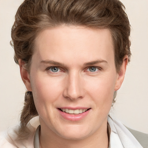 Joyful white young-adult female with medium  brown hair and grey eyes