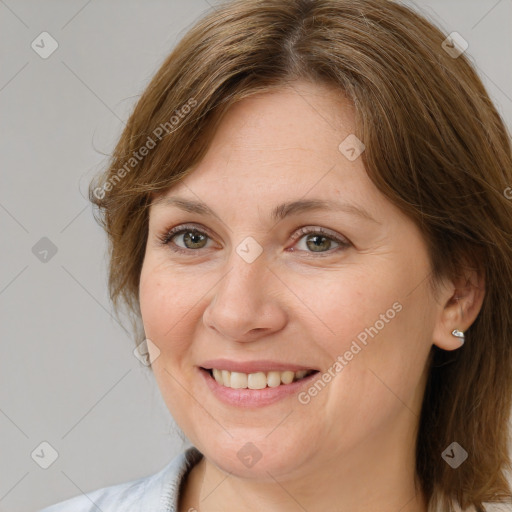 Joyful white adult female with medium  brown hair and grey eyes