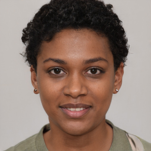 Joyful black young-adult female with short  black hair and brown eyes
