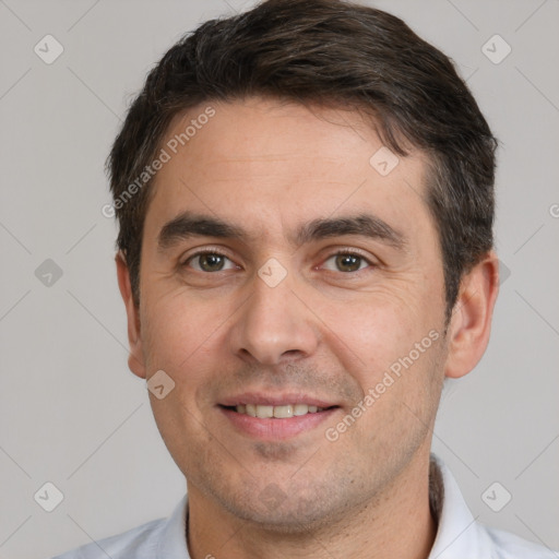 Joyful white adult male with short  brown hair and brown eyes