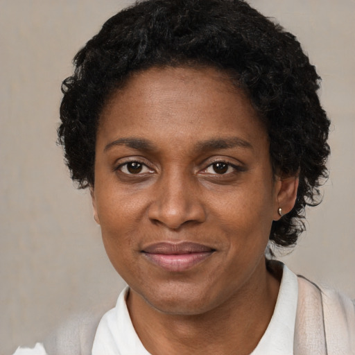 Joyful black adult female with short  brown hair and brown eyes