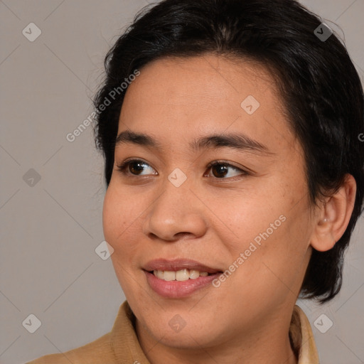 Joyful latino young-adult female with medium  brown hair and brown eyes