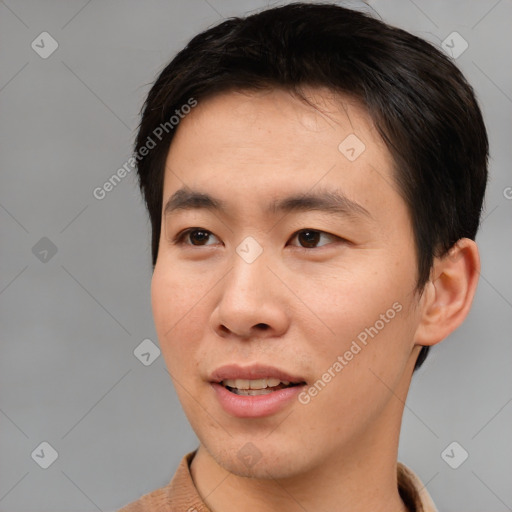 Joyful asian young-adult male with short  brown hair and brown eyes