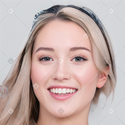 Joyful white young-adult female with long  brown hair and blue eyes