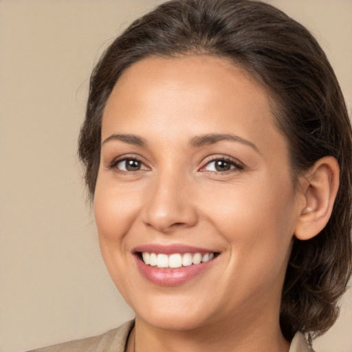 Joyful white young-adult female with medium  brown hair and brown eyes