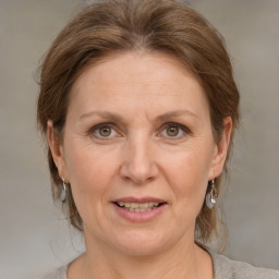 Joyful white adult female with medium  brown hair and grey eyes