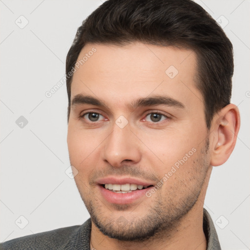 Joyful white young-adult male with short  brown hair and brown eyes