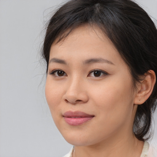 Joyful asian young-adult female with medium  brown hair and brown eyes
