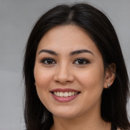 Joyful asian young-adult female with long  brown hair and brown eyes