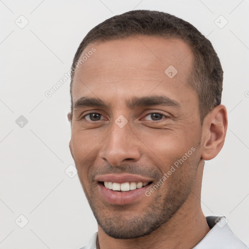 Joyful white young-adult male with short  black hair and brown eyes