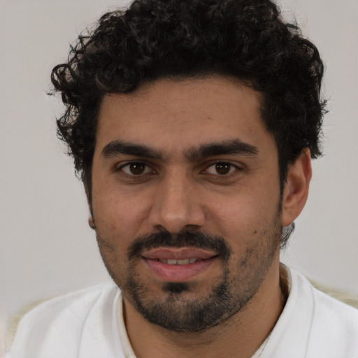 Joyful white young-adult male with short  black hair and brown eyes