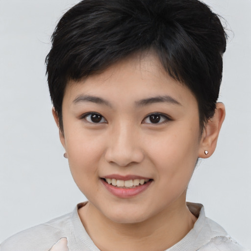 Joyful asian young-adult female with short  brown hair and brown eyes