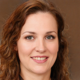 Joyful white young-adult female with long  brown hair and green eyes