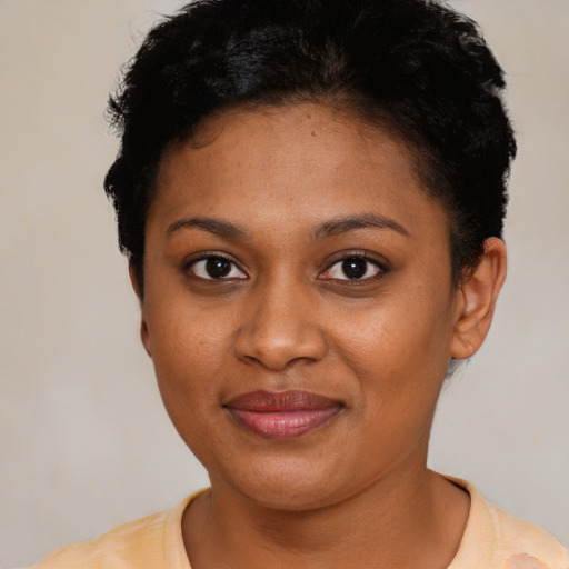 Joyful black young-adult female with short  brown hair and brown eyes