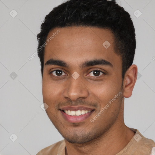 Joyful latino young-adult male with short  black hair and brown eyes