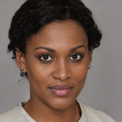 Joyful black young-adult female with short  brown hair and brown eyes
