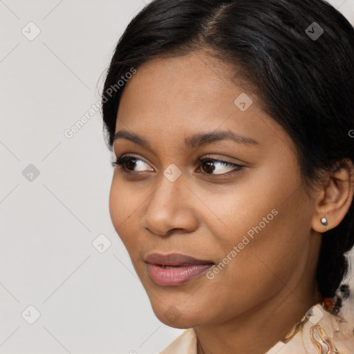 Joyful latino young-adult female with long  black hair and brown eyes