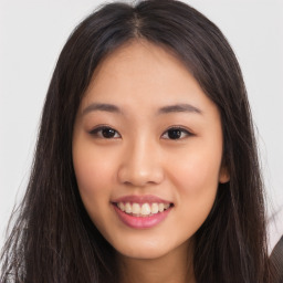 Joyful asian young-adult female with long  brown hair and brown eyes