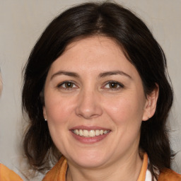 Joyful white adult female with medium  brown hair and brown eyes