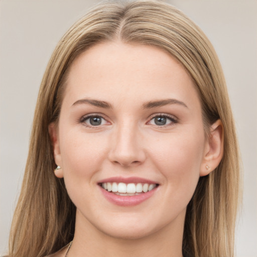 Joyful white young-adult female with long  brown hair and grey eyes