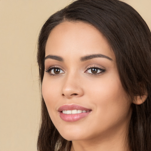 Joyful white young-adult female with long  black hair and brown eyes