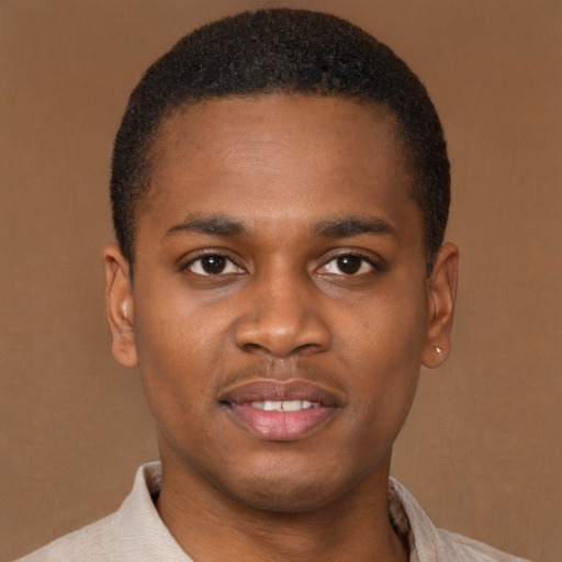 Joyful latino young-adult male with short  brown hair and brown eyes
