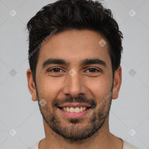 Joyful white young-adult male with short  black hair and brown eyes