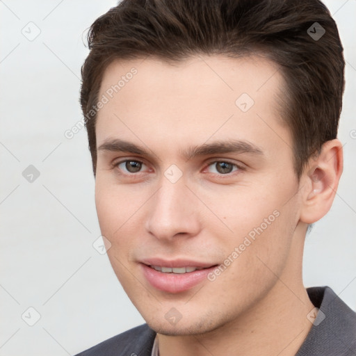 Joyful white young-adult male with short  brown hair and brown eyes