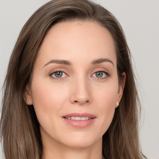 Joyful white young-adult female with long  brown hair and grey eyes