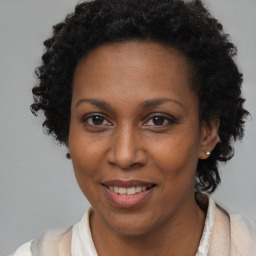 Joyful black adult female with short  brown hair and brown eyes