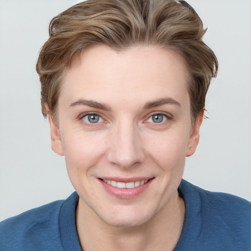 Joyful white young-adult female with short  brown hair and blue eyes