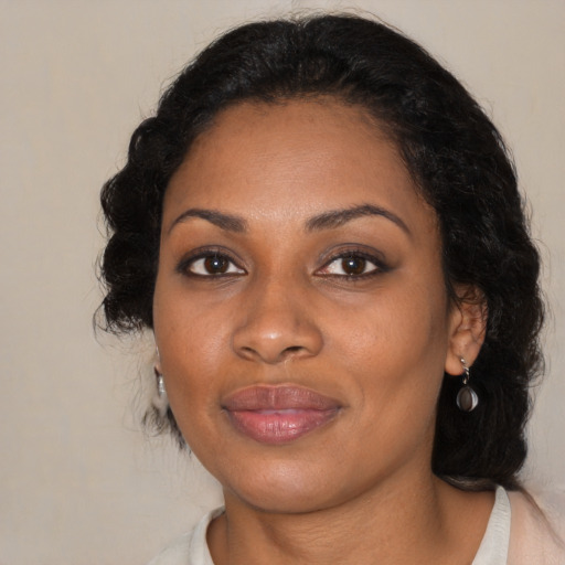 Joyful black adult female with medium  black hair and brown eyes