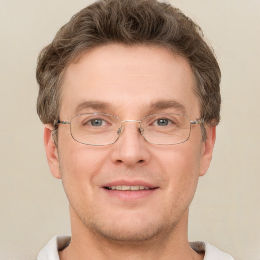 Joyful white adult male with short  brown hair and grey eyes