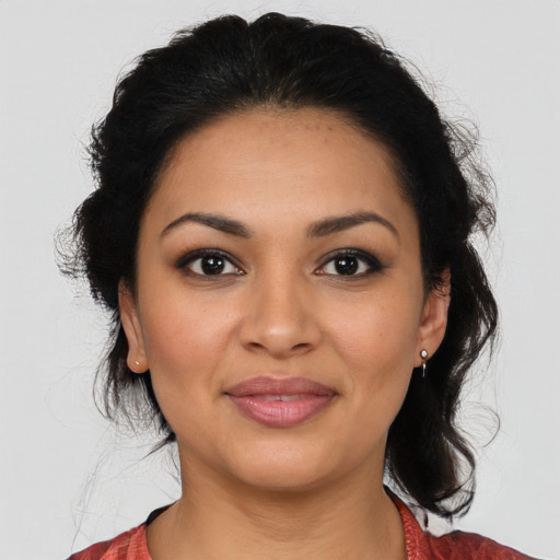 Joyful latino young-adult female with medium  brown hair and brown eyes