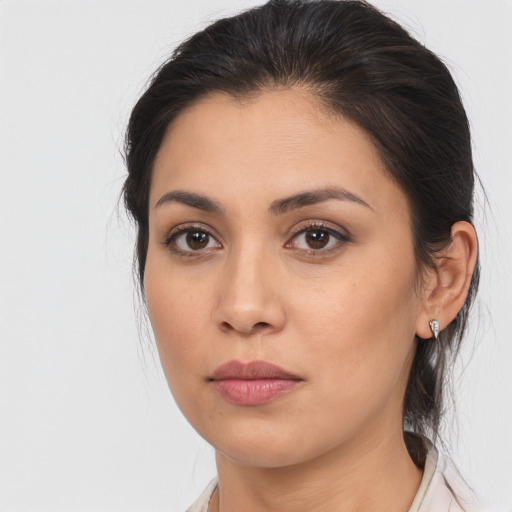 Joyful latino young-adult female with medium  brown hair and brown eyes