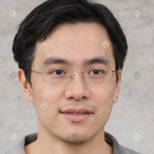 Joyful asian young-adult male with short  black hair and brown eyes