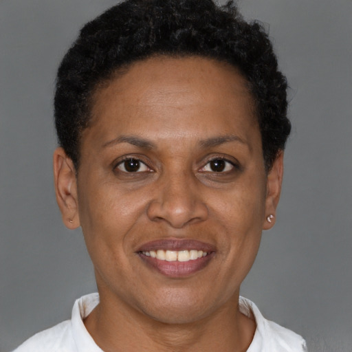 Joyful latino adult female with short  brown hair and brown eyes